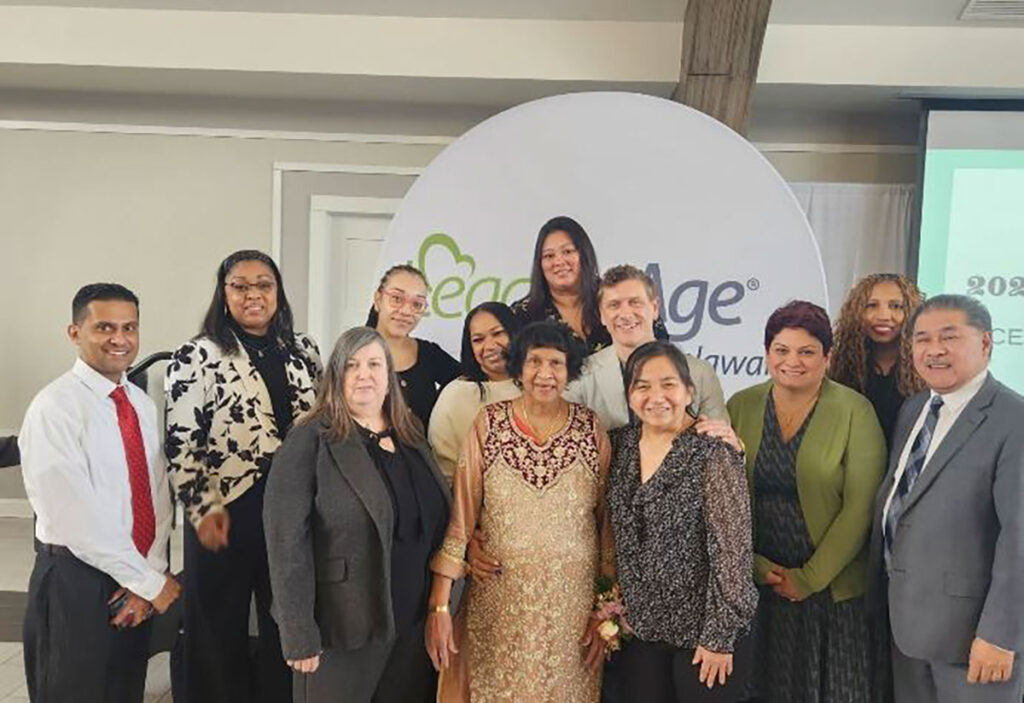 Lily is pictured with her family and Peace Care Team members
